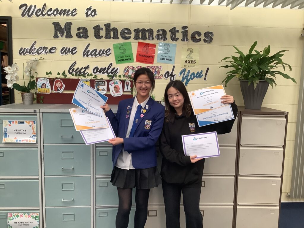 Anne-Marie and Ciao showing off their certificates from the UKMT maths competition